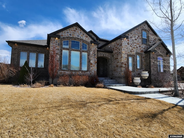 303 Tamarack Dr, Rock Springs, WY 82901 - view of front of home with stone siding and a front yard