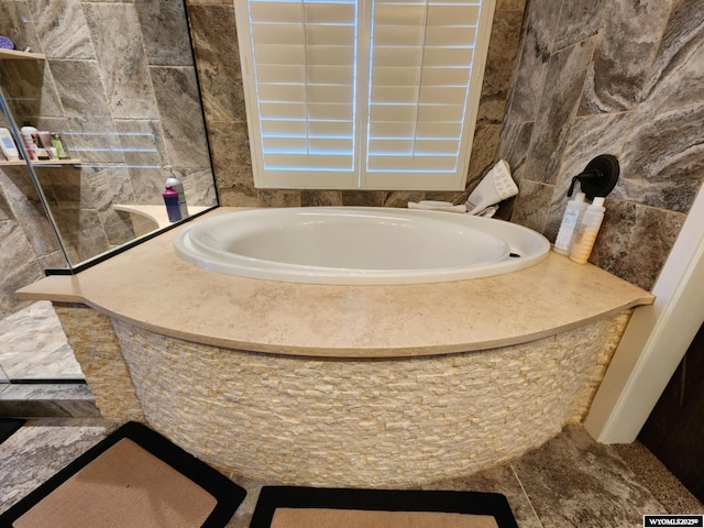 303 Tamarack Dr, Rock Springs, WY 82901 - bathroom with a bathing tub and tile walls