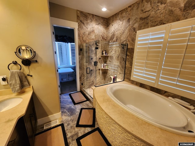303 Tamarack Dr, Rock Springs, WY 82901 - full bathroom with vanity, baseboards, visible vents, tiled shower, and a bath