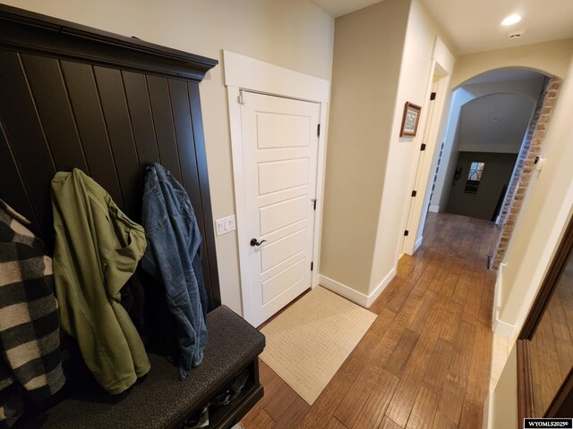 303 Tamarack Dr, Rock Springs, WY 82901 - mudroom featuring arched walkways, baseboards, and wood finished floors