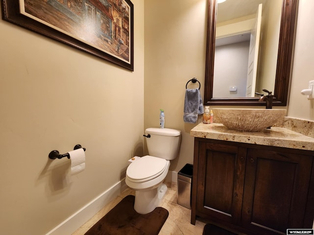 303 Tamarack Dr, Rock Springs, WY 82901 - bathroom featuring baseboards, toilet, tile patterned floors, and vanity