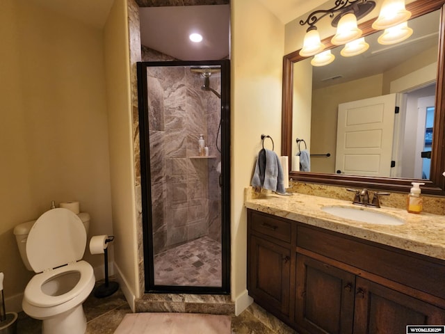 303 Tamarack Dr, Rock Springs, WY 82901 - full bathroom with toilet, vanity, a shower stall, baseboards, and visible vents