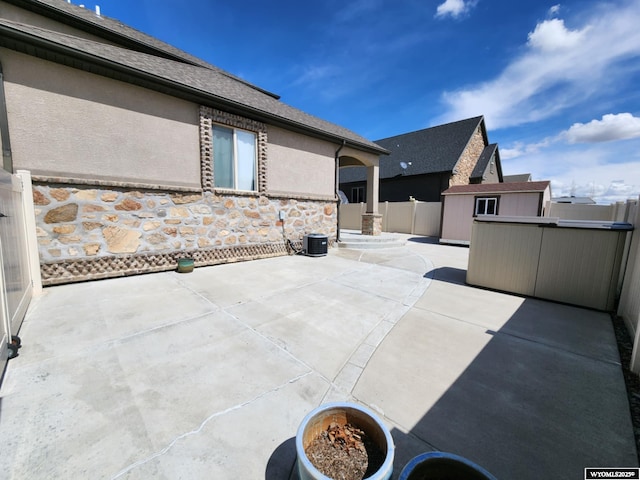 303 Tamarack Dr, Rock Springs, WY 82901 - view of patio featuring an outdoor structure, fence, and a storage shed