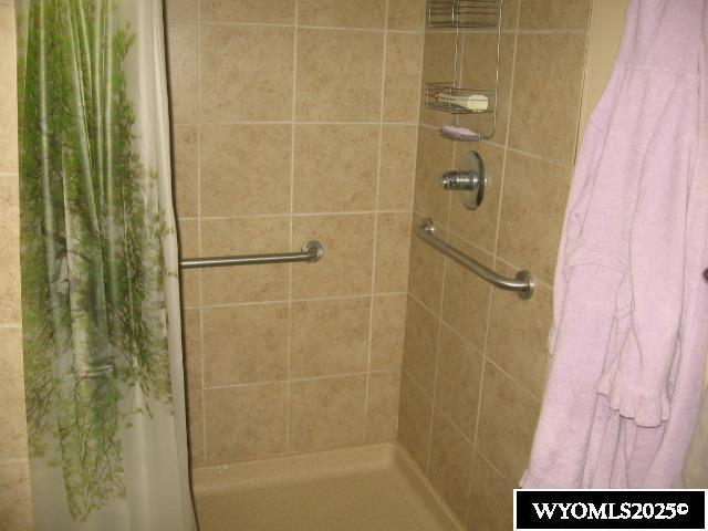 full bath with a tile shower