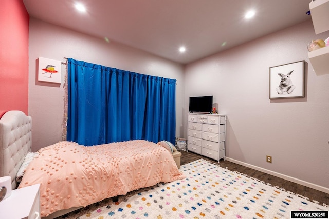bedroom featuring baseboards, wood finished floors, and recessed lighting