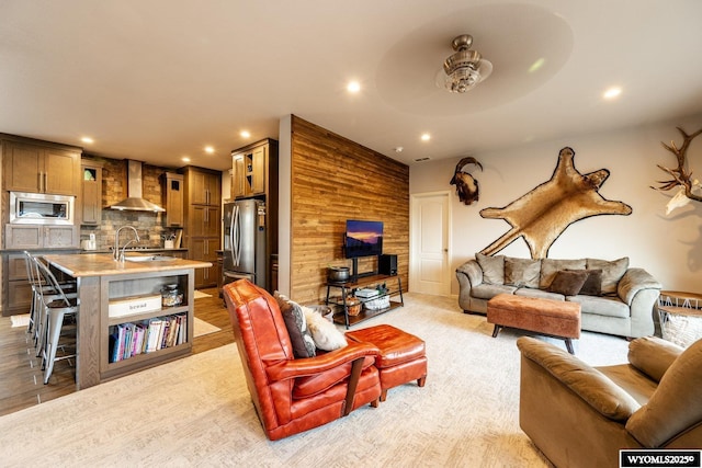 living area with recessed lighting and light colored carpet