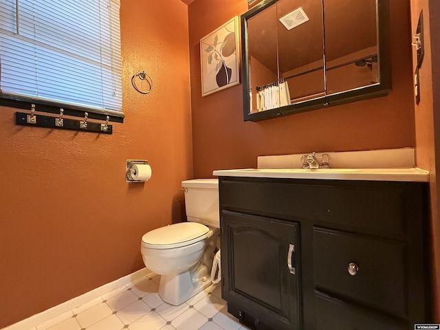 bathroom with visible vents, baseboards, toilet, tile patterned floors, and vanity