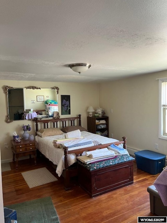 419 6th St, Rawlins, WY 82301 - bedroom with baseboards, wood finished floors, and a textured ceiling