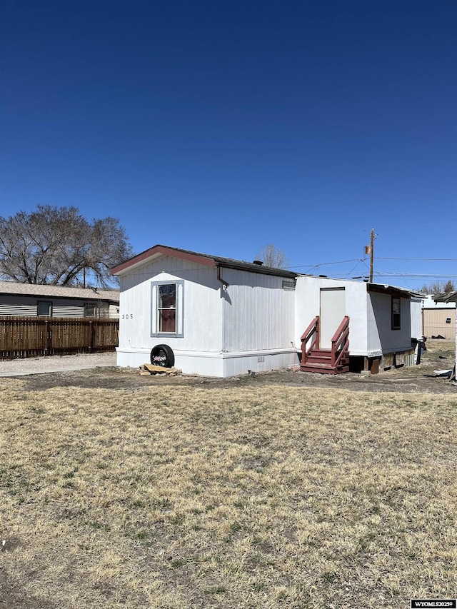 305 E Center St, Rawlins, WY 82301 - exterior space with entry steps, fence, and a lawn