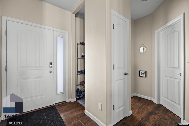 foyer featuring dark wood-style flooring and baseboards