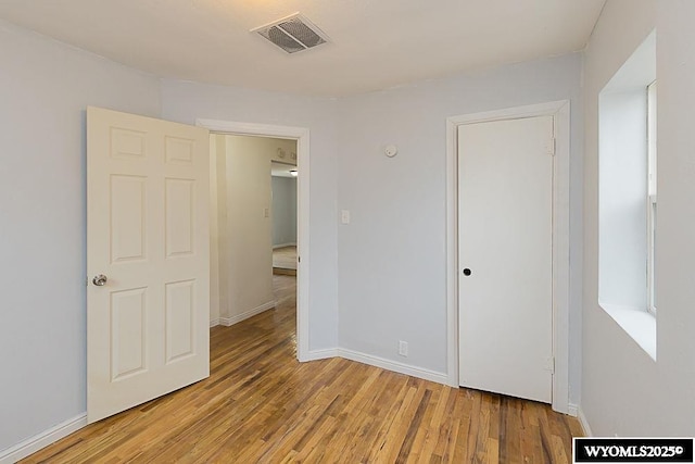630 Ludvig St, Rock Springs, WY 82901 - unfurnished bedroom with visible vents, baseboards, and light wood finished floors
