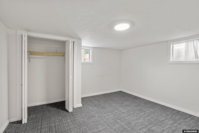432 15th St, Evanston, WY 82930 - unfurnished bedroom with a textured ceiling, dark colored carpet, and a closet
