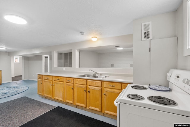 432 15th St, Evanston, WY 82930 - kitchen featuring white electric range, light countertops, and a textured ceiling