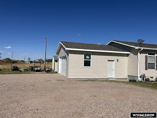 2720 State Highway 414 N, Lyman, WY 82937 - exterior space with a garage, driveway, and roof with shingles