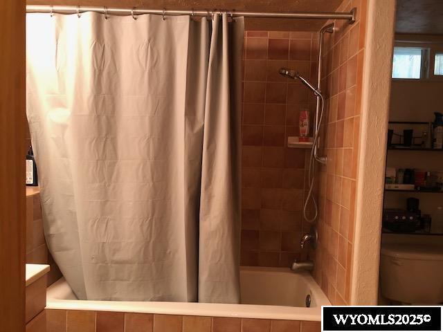 816 Center St, Rock Springs, WY 82901 - full bath featuring shower / bath combination with curtain and toilet