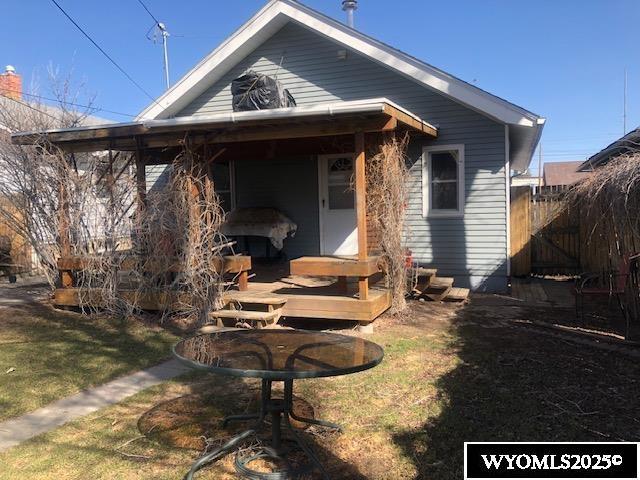 816 Center St, Rock Springs, WY 82901 - rear view of house with fence and a lawn