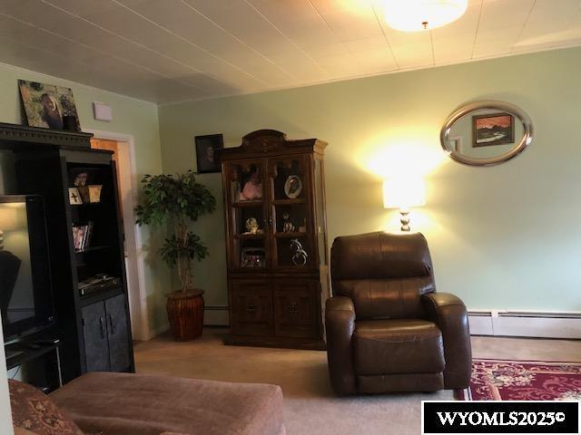 816 Center St, Rock Springs, WY 82901 - sitting room featuring carpet flooring, a baseboard heating unit, and baseboard heating