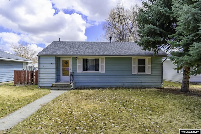 707 S 6th St, Basin, WY 82410 - view of front of home with a shingled roof, fence, and a front lawn