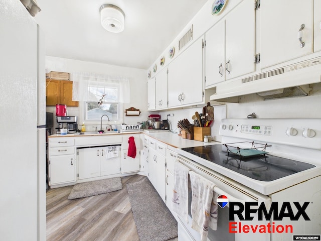 707 S 6th St, Basin, WY 82410 - kitchen with a sink, white cabinets, white appliances, and under cabinet range hood