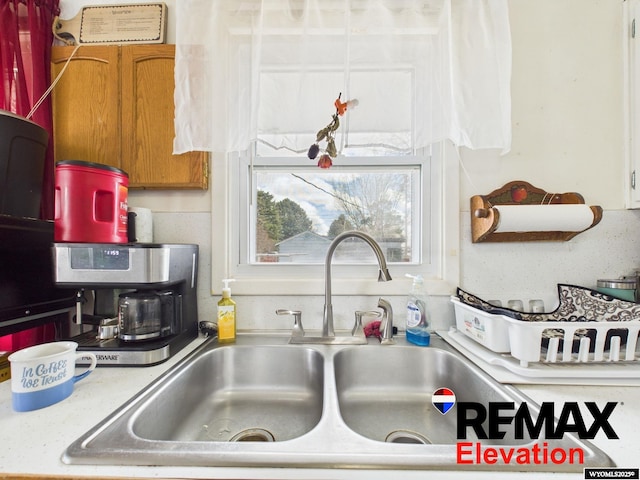 707 S 6th St, Basin, WY 82410 - details with brown cabinetry, light countertops, and a sink