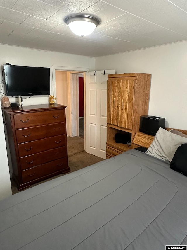 bedroom featuring dark colored carpet