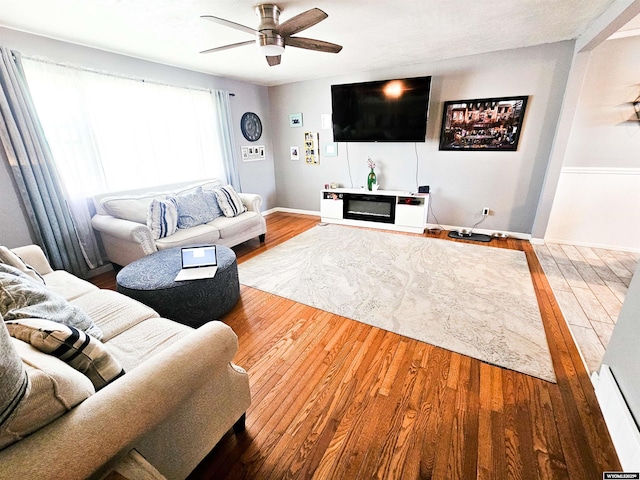 3617 Bighorn St, Torrington, WY 82240 - living room featuring wood finished floors, baseboards, and a ceiling fan