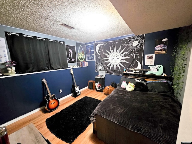 3617 Bighorn St, Torrington, WY 82240 - bedroom with a textured ceiling, wood finished floors, and baseboards