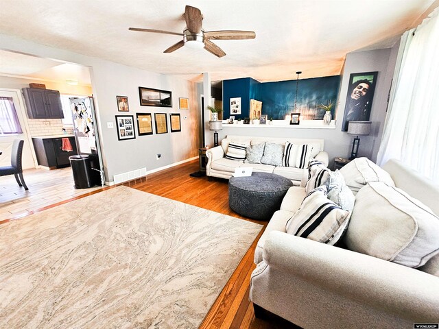 3617 Bighorn St, Torrington, WY 82240 - living area with baseboards, light wood finished floors, ceiling fan, and visible vents