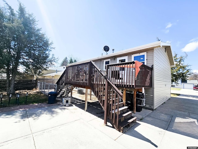 3617 Bighorn St, Torrington, WY 82240 - rear view of property featuring fence, a wooden deck, and stairs