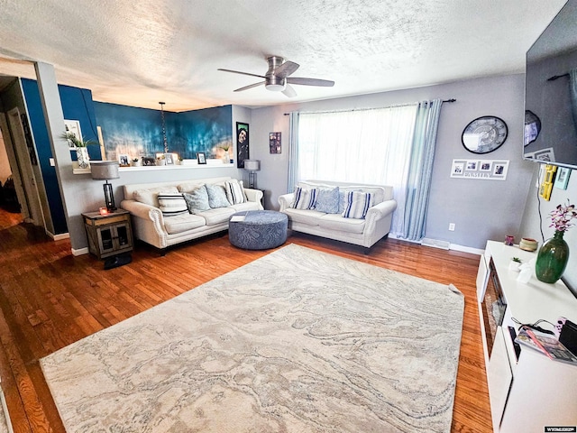 3617 Bighorn St, Torrington, WY 82240 - living room with baseboards, a textured ceiling, a ceiling fan, and wood finished floors