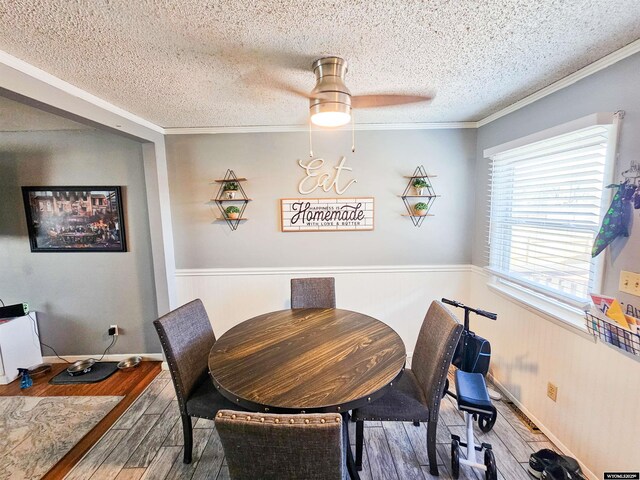 3617 Bighorn St, Torrington, WY 82240 - dining area featuring a textured ceiling, ornamental molding, a ceiling fan, and wood finished floors