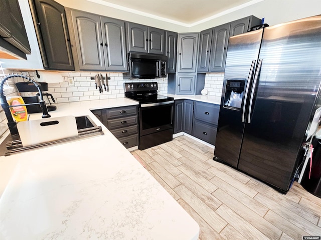 3617 Bighorn St, Torrington, WY 82240 - kitchen with stainless steel refrigerator with ice dispenser, black microwave, wood finish floors, decorative backsplash, and electric range