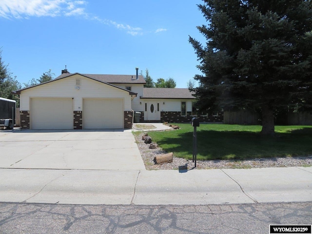1001 Cheshire St, Casper, WY 82609 - single story home with a front yard, a garage, and concrete driveway