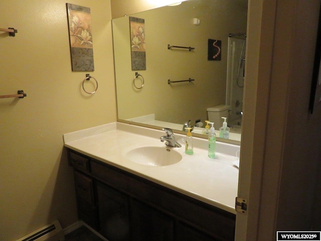 1001 Cheshire St, Casper, WY 82609 - bathroom featuring toilet, a baseboard radiator, vanity, and curtained shower