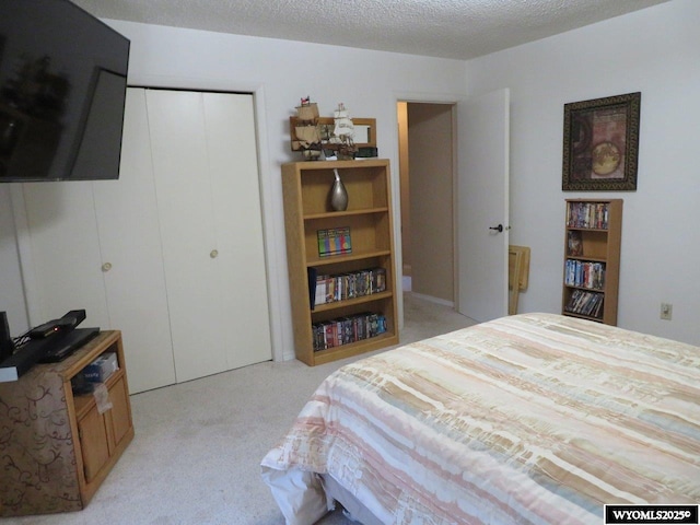 1001 Cheshire St, Casper, WY 82609 - bedroom featuring a closet, light colored carpet, and a textured ceiling
