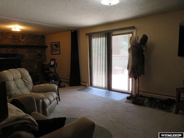 1001 Cheshire St, Casper, WY 82609 - living area featuring a baseboard heating unit, a fireplace, a textured ceiling, and carpet floors