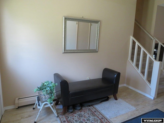 1001 Cheshire St, Casper, WY 82609 - sitting room featuring stairway, a baseboard heating unit, baseboards, and wood finished floors