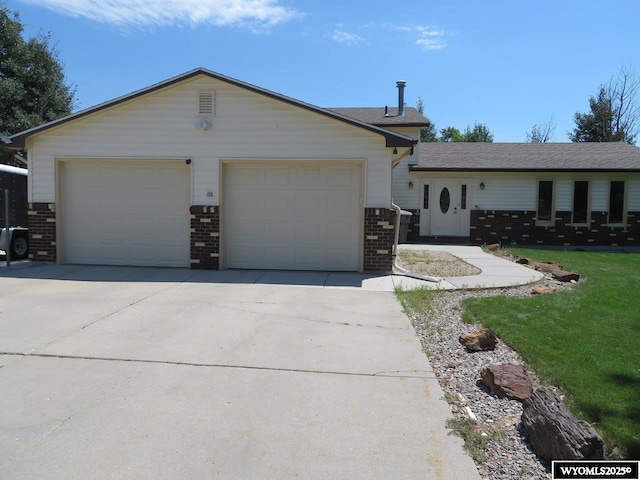1001 Cheshire St, Casper, WY 82609 - ranch-style house with a garage and brick siding