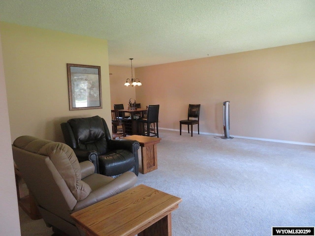1001 Cheshire St, Casper, WY 82609 - living area with carpet, a notable chandelier, a textured ceiling, and baseboards