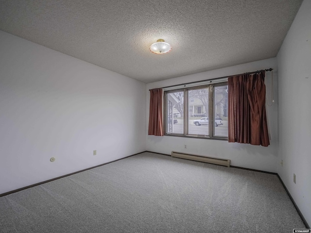 carpeted empty room featuring a textured ceiling, a baseboard heating unit, and baseboards