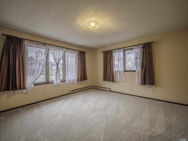 spare room with a wealth of natural light, carpet flooring, and baseboards