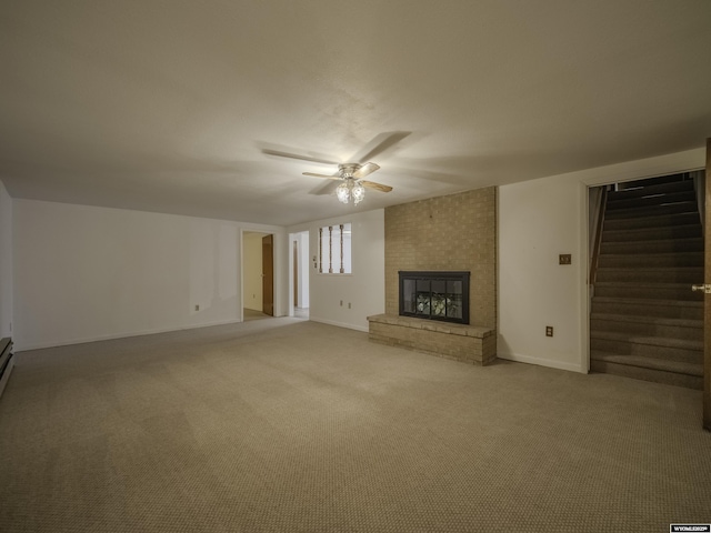 unfurnished living room with a ceiling fan, light carpet, a brick fireplace, stairs, and baseboards