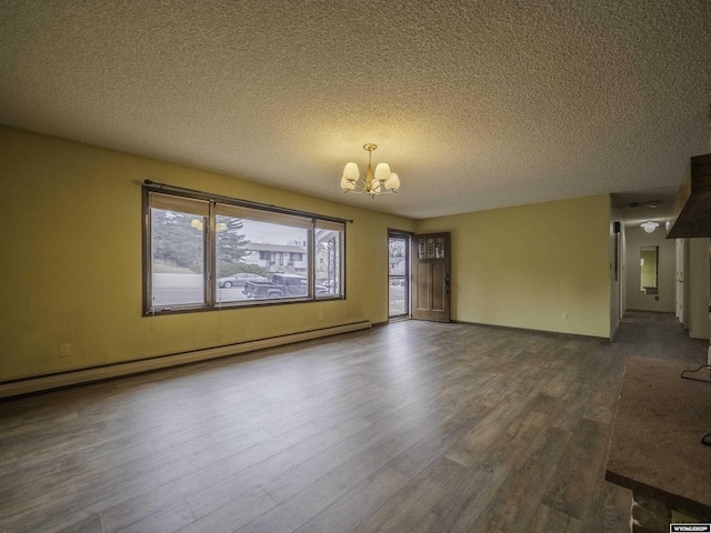 empty room featuring baseboard heating, baseboards, an inviting chandelier, a textured ceiling, and dark wood finished floors