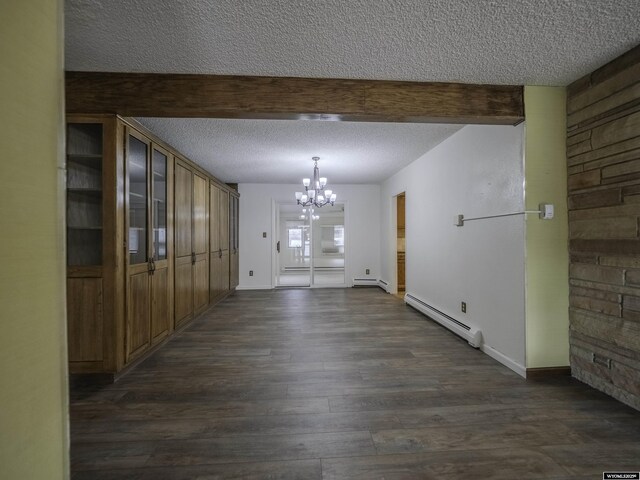 unfurnished dining area with a notable chandelier, a baseboard radiator, a textured ceiling, and dark wood finished floors