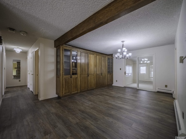 unfurnished dining area with dark wood-style flooring, a notable chandelier, a baseboard heating unit, and beam ceiling