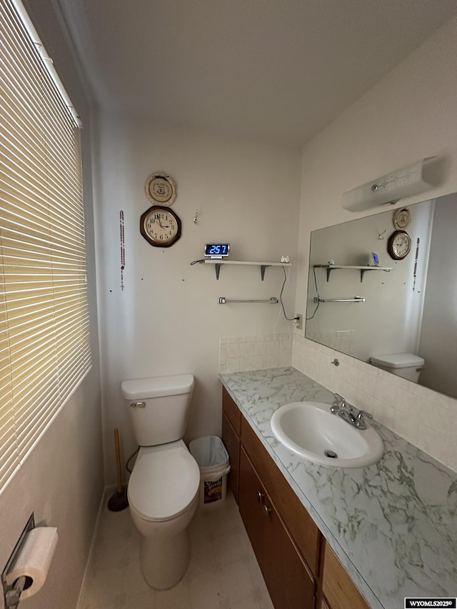 341 E 29th Ave, Torrington, WY 82240 - bathroom with toilet, vanity, and baseboards