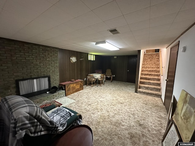 341 E 29th Ave, Torrington, WY 82240 - living area with wood walls, carpet, visible vents, and stairs