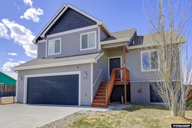 view of front of house with a garage, roof with shingles, driveway, and fence