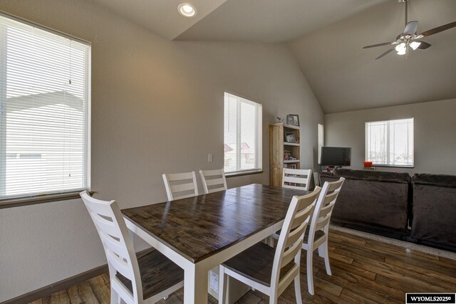 dining room with a healthy amount of sunlight, wood finished floors, ceiling fan, and lofted ceiling