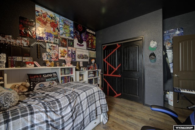 bedroom with wood finished floors